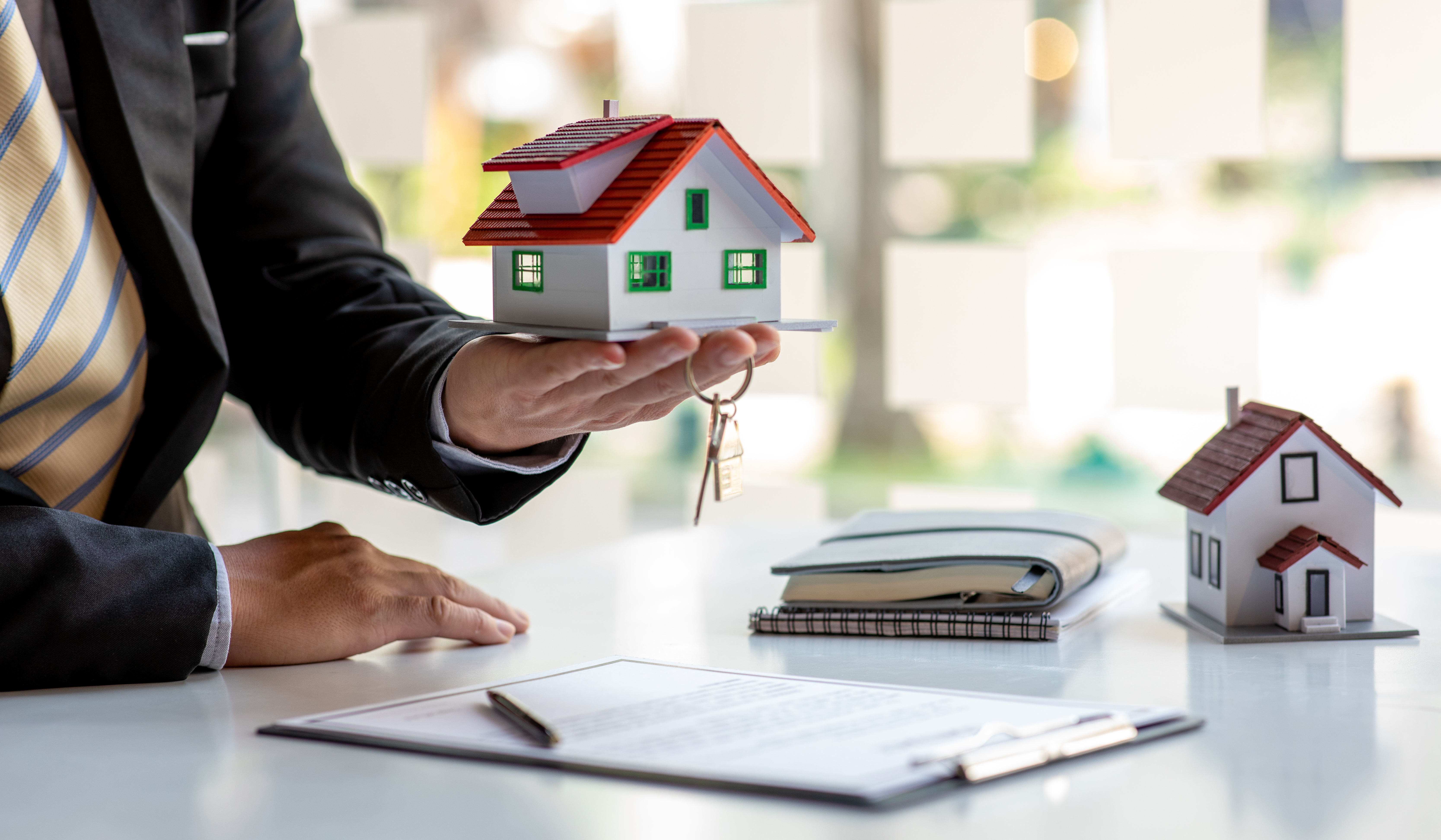 Cash home buyer presenting as-is house purchase with keys and contract Cash home buyer presenting as-is house purchase with keys and contract