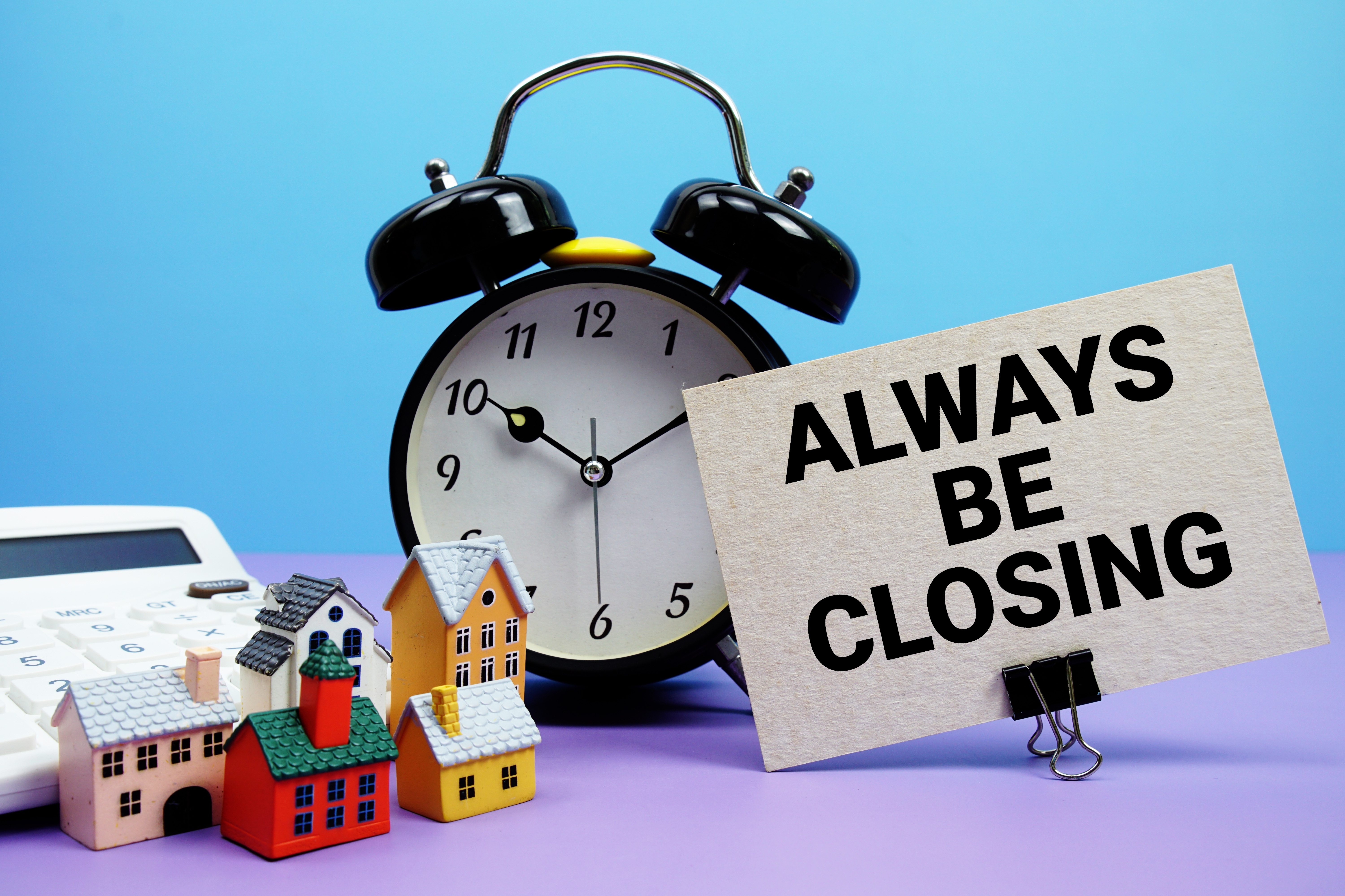 House sale closing timeline concept with clock calculator and miniature homes House sale closing timeline concept with clock calculator and miniature homes