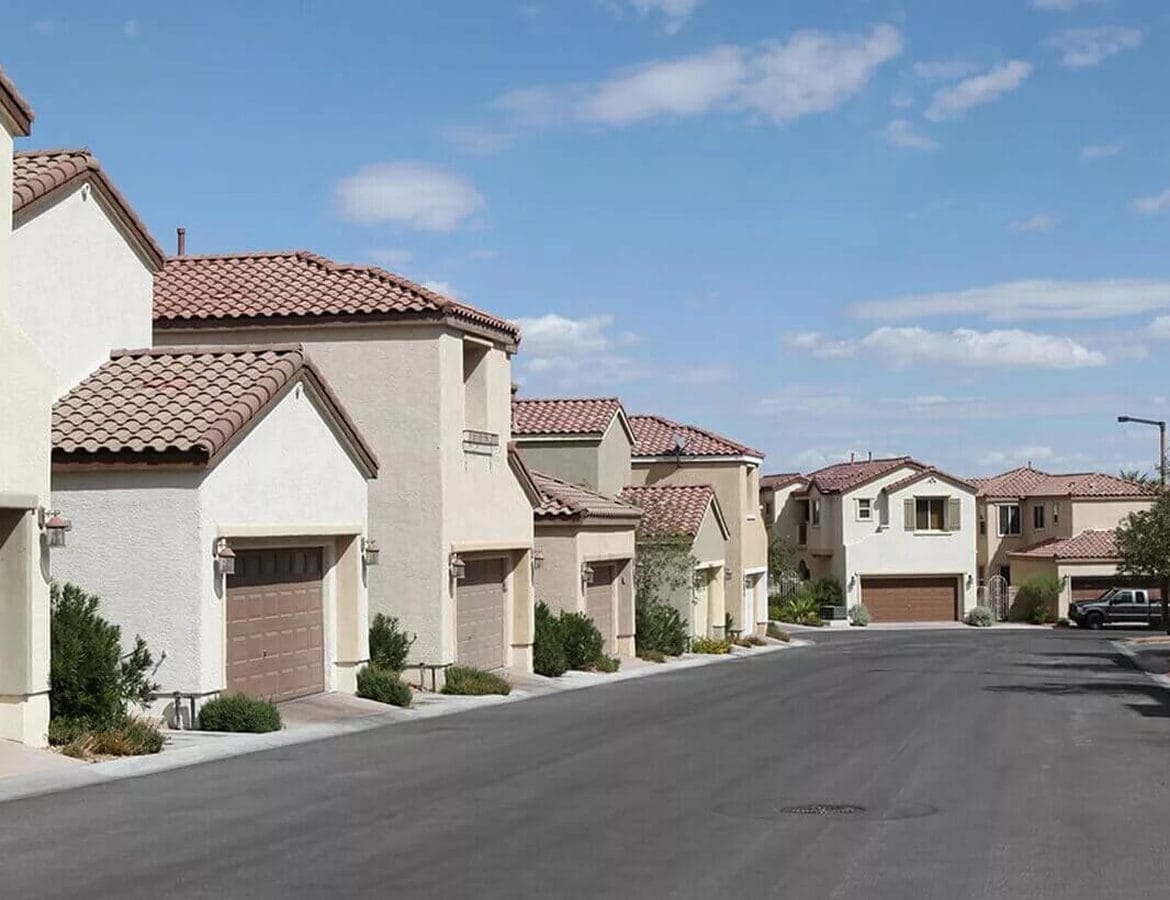Street of tile-roof single-family homes in a Las Vegas, NV neighborhood where Cash for Vegas Homes buys houses
